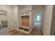 Hallway featuring a custom built-in bench, hardwood floors, and access to rooms at 105 Leisure Ln, Louisburg, NC 27549