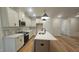 Well-equipped kitchen with an island, stainless steel appliances, and hardwood flooring at 105 Leisure Ln, Louisburg, NC 27549
