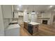 Spacious kitchen featuring an island, stainless appliances, hardwood floors, and an open floorplan at 105 Leisure Ln, Louisburg, NC 27549