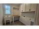 Functional laundry room with sink, counter space, cabinets, and hexagon tiled floors at 105 Leisure Ln, Louisburg, NC 27549