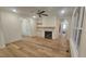 Bright living room with hardwood floors, fireplace, built-in shelving, and white walls at 105 Leisure Ln, Louisburg, NC 27549