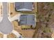 Aerial view of home with driveway, mature trees, and a well-maintained yard at 105 Mystic Quartz Ln, Holly Springs, NC 27540