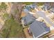 Aerial view of the home, neighborhood, a community pool, and surrounding mature trees at 105 Mystic Quartz Ln, Holly Springs, NC 27540