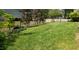 Spacious backyard featuring a lush lawn and a sleek black metal fence at 105 Mystic Quartz Ln, Holly Springs, NC 27540
