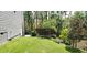 Beautiful backyard with a well-manicured lawn, privacy fence, and mature trees at 105 Mystic Quartz Ln, Holly Springs, NC 27540