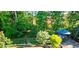 Outdoor living space featuring a deck, umbrella-covered table, and wooded views at 105 Mystic Quartz Ln, Holly Springs, NC 27540