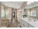 Upscale bathroom with tiled flooring, walk-in shower with glass door, and soaking tub at 105 Mystic Quartz Ln, Holly Springs, NC 27540