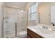 Well-lit bathroom showcasing a glass enclosed shower and vanity with sleek hardware at 105 Mystic Quartz Ln, Holly Springs, NC 27540