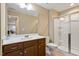 Bathroom featuring a glass enclosed shower and vanity with sleek hardware at 105 Mystic Quartz Ln, Holly Springs, NC 27540