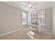 Cozy bedroom shows chair rail, neutral paint, and a desk with ample sunlight at 105 Mystic Quartz Ln, Holly Springs, NC 27540