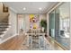 Bright dining room with access to screened porch features table, painting, and hardwood floors at 105 Mystic Quartz Ln, Holly Springs, NC 27540