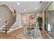 Dining area with hardwood floors, staircase, and sliding glass doors to outdoor area at 105 Mystic Quartz Ln, Holly Springs, NC 27540