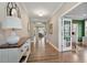 Inviting entryway with hardwood floors, elegant console table, and decorative mirror above at 105 Mystic Quartz Ln, Holly Springs, NC 27540