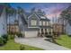 Beautiful craftsman home with a well-manicured lawn, 2-car garage and covered front porch at 105 Mystic Quartz Ln, Holly Springs, NC 27540
