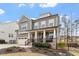 Attractive home boasting a covered front porch, and a beautifully landscaped front yard at 105 Mystic Quartz Ln, Holly Springs, NC 27540