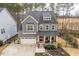 Charming two-story home showcasing a red front door, manicured lawn, and inviting curb appeal at 105 Mystic Quartz Ln, Holly Springs, NC 27540