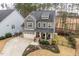 Charming two-story home featuring gray siding, red door, landscaped front yard and attached two-car garage at 105 Mystic Quartz Ln, Holly Springs, NC 27540