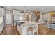 The open-concept kitchen features a central island, granite countertops, and white cabinetry at 105 Mystic Quartz Ln, Holly Springs, NC 27540