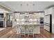 Bright, eat-in kitchen features a large island, granite countertops, and stainless steel appliances at 105 Mystic Quartz Ln, Holly Springs, NC 27540