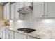 Close up view of the kitchen shows granite counter tops and subway tile backsplash at 105 Mystic Quartz Ln, Holly Springs, NC 27540