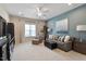 Living room with comfortable seating, ceiling fan, and large window offers a relaxing atmosphere at 105 Mystic Quartz Ln, Holly Springs, NC 27540