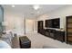 Spacious living room with television, comfortable seating, and ample natural light at 105 Mystic Quartz Ln, Holly Springs, NC 27540
