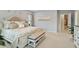 Bright Primary bedroom with tray ceiling, upholstered bed, bench, and neutral color palette at 105 Mystic Quartz Ln, Holly Springs, NC 27540