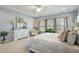 Relaxing Primary bedroom with tray ceiling, decorative accents, and large windows at 105 Mystic Quartz Ln, Holly Springs, NC 27540