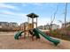 Community playground with slides, climbing structures, and a wood chip ground covering at 105 Mystic Quartz Ln, Holly Springs, NC 27540