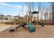 Community playground with slides, climbing structures, and a wood chip ground covering at 105 Mystic Quartz Ln, Holly Springs, NC 27540