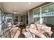 Cozy screened porch featuring comfortable wicker furniture, ceiling fan, and tranquil outdoor views at 105 Mystic Quartz Ln, Holly Springs, NC 27540