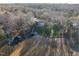 Aerial view showcasing home with lake frontage surrounded by trees at 106 Nashua Cv, Louisburg, NC 27549