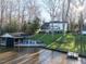 Aerial view of a home with lakeside dock and boat house at 106 Nashua Cv, Louisburg, NC 27549
