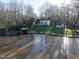 Aerial view of home with boat dock on a grassy lawn leading to lake at 106 Nashua Cv, Louisburg, NC 27549