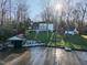 Aerial view of lake front property showing home and boat dock at 106 Nashua Cv, Louisburg, NC 27549