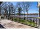Spacious back deck with railing, offering serene views of the lake and surrounding landscape at 106 Nashua Cv, Louisburg, NC 27549