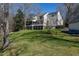 Exterior shot of the back of the home showcasing yard with lake views at 106 Nashua Cv, Louisburg, NC 27549