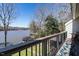 Balcony view overlooking the lake and boat dock, framed by mature trees at 106 Nashua Cv, Louisburg, NC 27549