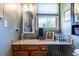 Well-lit bathroom showcasing wooden vanity with a framed mirror at 106 Nashua Cv, Louisburg, NC 27549