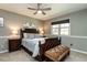 Cozy bedroom with neutral walls, patterned bedding, and ample natural light at 106 Nashua Cv, Louisburg, NC 27549
