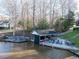 Lakeside boat dock with boat house, seating, and fire pit at 106 Nashua Cv, Louisburg, NC 27549