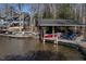 Well-maintained boat dock with covered boat storage and lounge chairs on the lake at 106 Nashua Cv, Louisburg, NC 27549