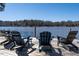 Relaxing dock seating area with Adirondack chairs offering stunning lake views at 106 Nashua Cv, Louisburg, NC 27549