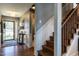 Home entryway featuring hardwood floors, staircase, and lots of natural light at 106 Nashua Cv, Louisburg, NC 27549