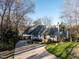 Traditional home with mature trees and curved driveway leading to attached garage at 106 Nashua Cv, Louisburg, NC 27549