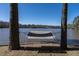 Relaxing hammock strung between two trees overlooking a serene lake view at 106 Nashua Cv, Louisburg, NC 27549