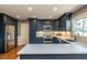 Modern kitchen with stainless steel appliances, white countertops, and ample cabinet space at 106 Nashua Cv, Louisburg, NC 27549