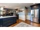 Bright, airy kitchen with stainless steel refrigerator and island with marble countertops at 106 Nashua Cv, Louisburg, NC 27549