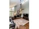 Vaulted living room with fireplace, ceiling fan, large rug, and leather furniture at 106 Nashua Cv, Louisburg, NC 27549