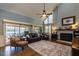 Spacious living room with high ceilings, fireplace, and access to an outdoor patio at 106 Nashua Cv, Louisburg, NC 27549
